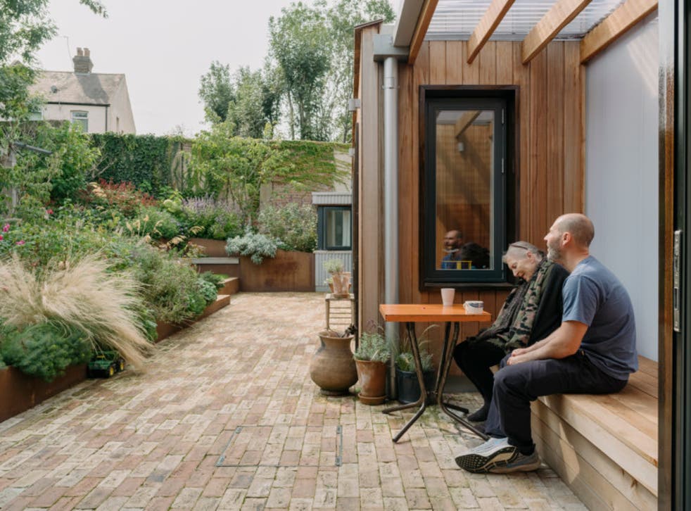 <p>Christine and Ben Magid surrounded by lovely old trees in the terraced garden</p>