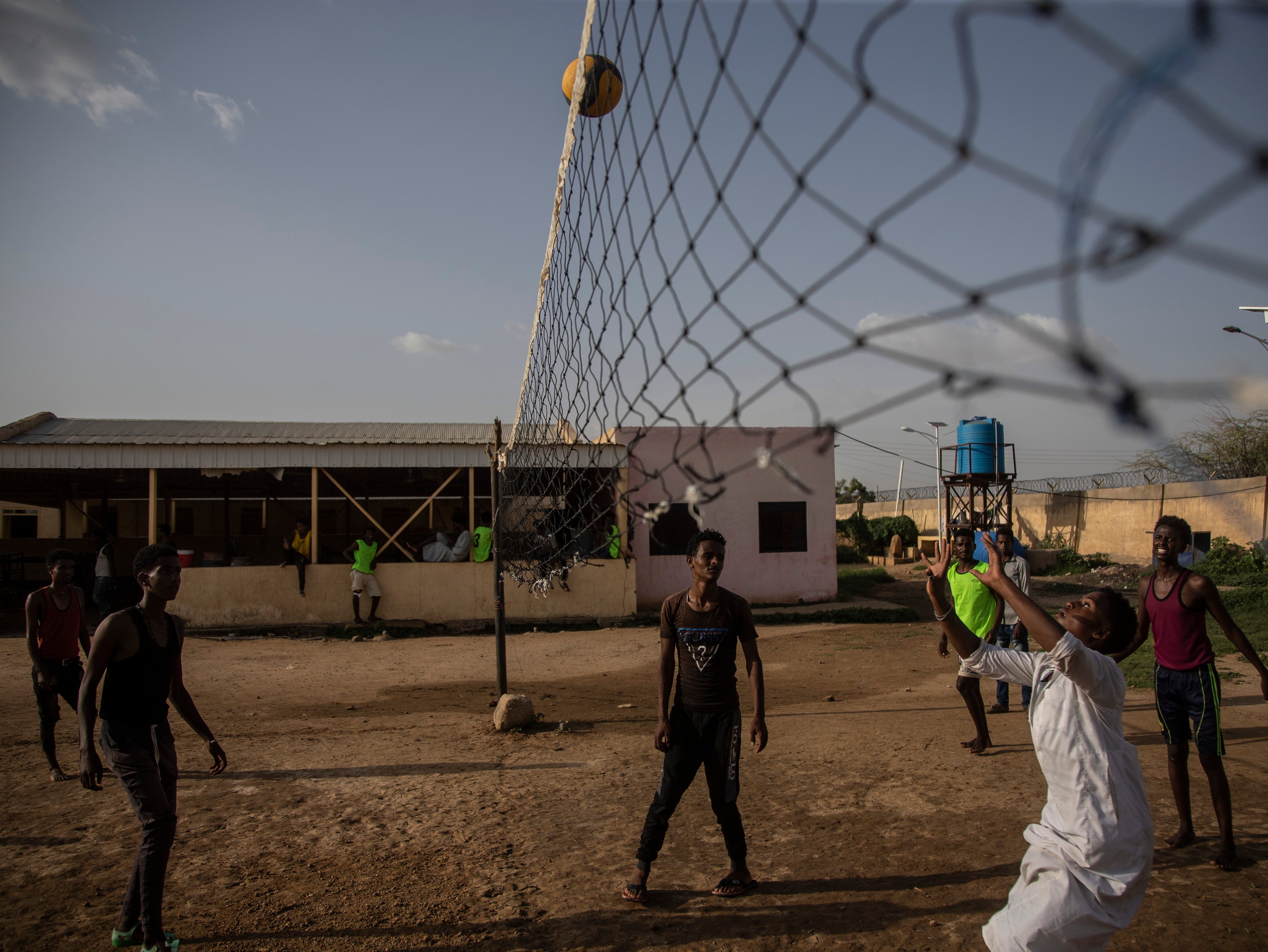 Eritreans refugees play volleyball in a transit centre for new refugees arrivals from Eritrea in Wadsharefy, Sudan