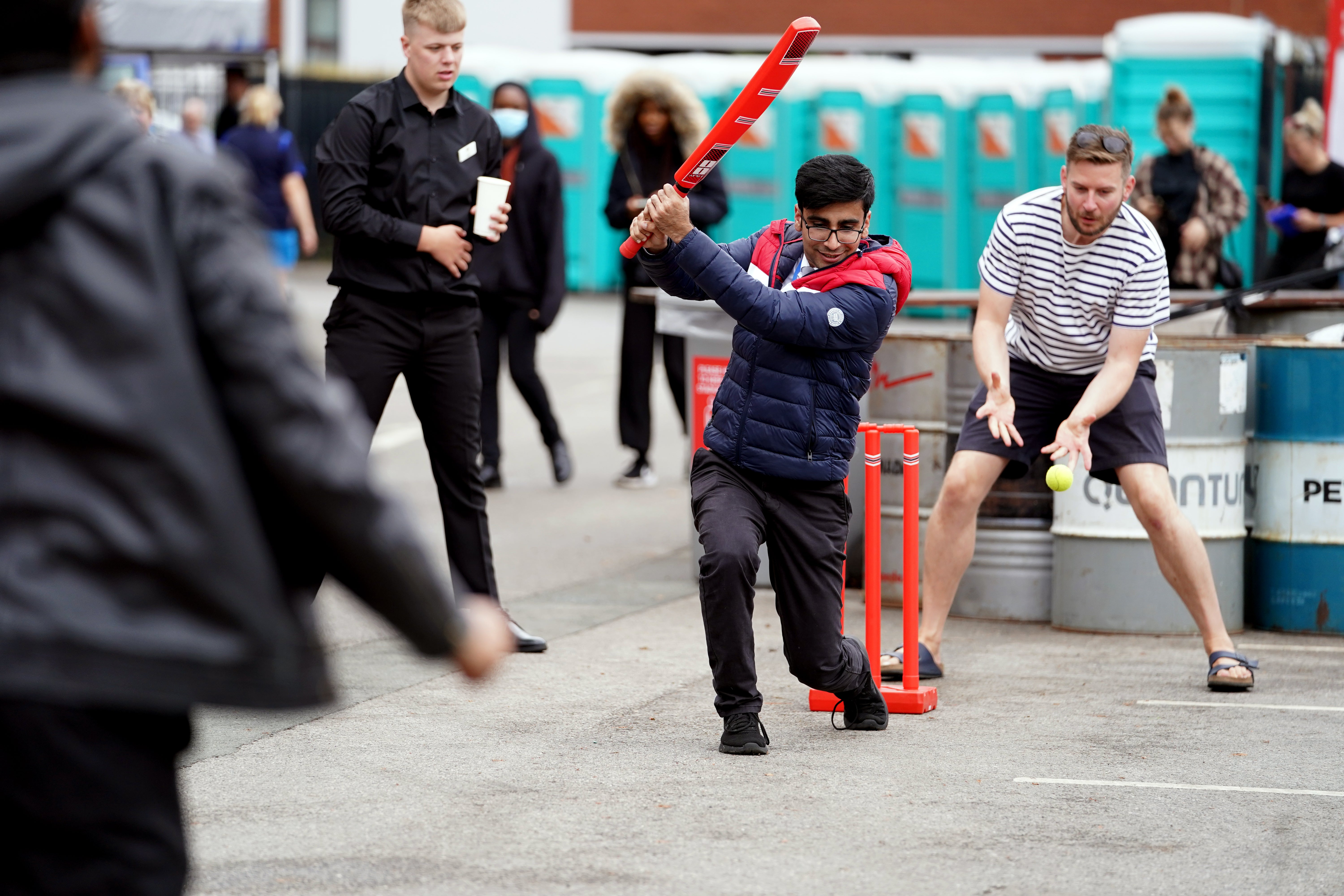 Fans play cricket outside of Old Trafford after the match was cancelled (Martin Rickett/PA)