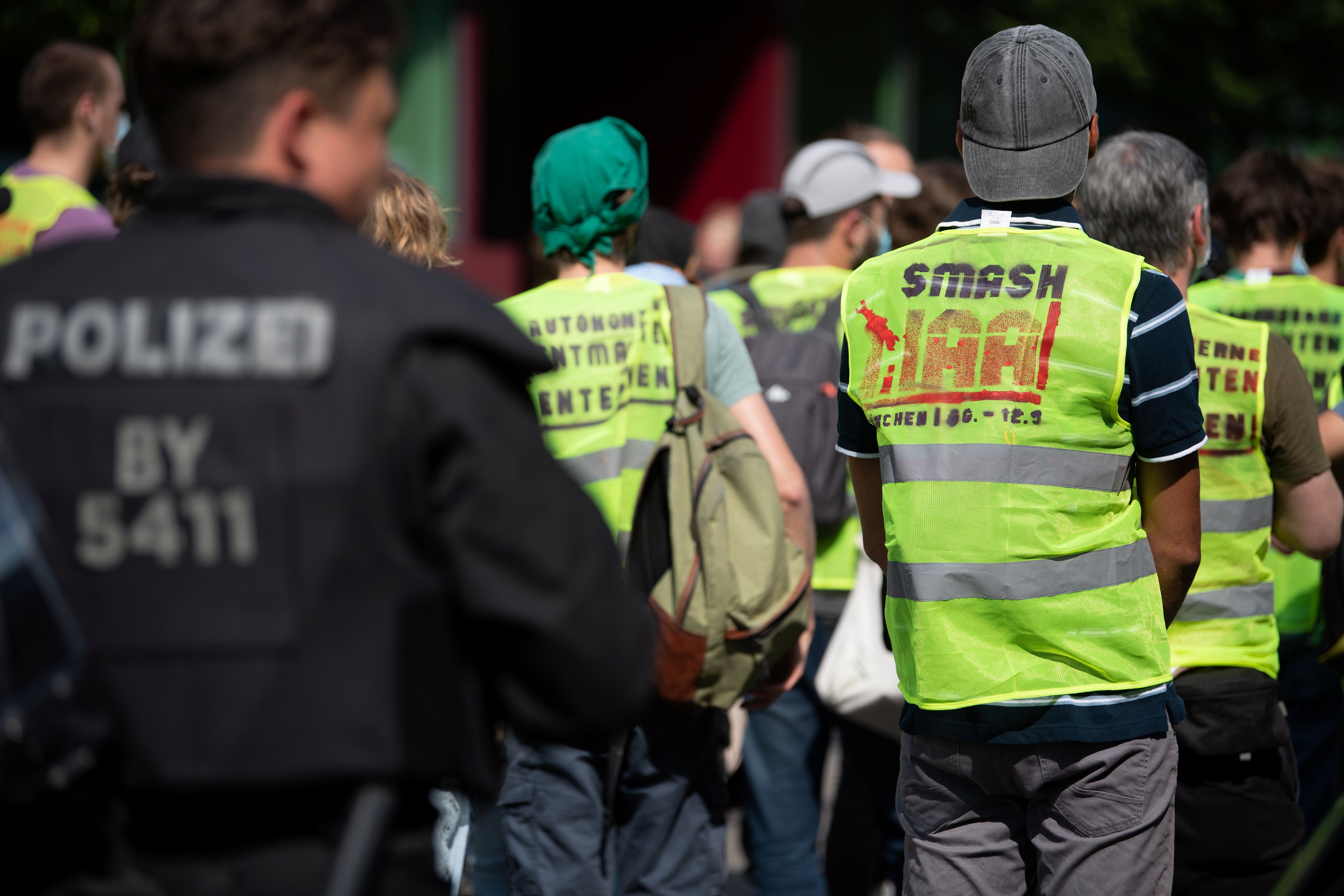 An environmental activist wearing a vest with the slogan ‘Smash IAA'