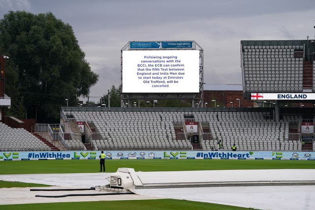 The big screen at an empty Emirates Old Trafford carries the news of the cancelled Test (Martin Rickett/PA)