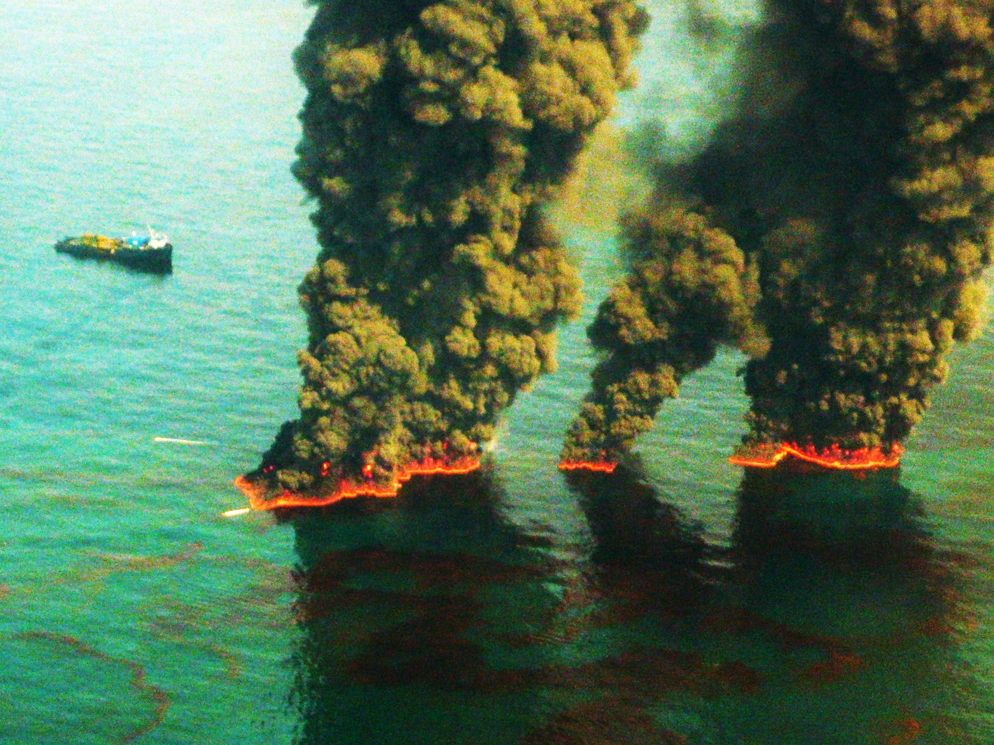 Plumes of smoke rise from a controlled burn during the Deepwater Horizon oil spill in 2010