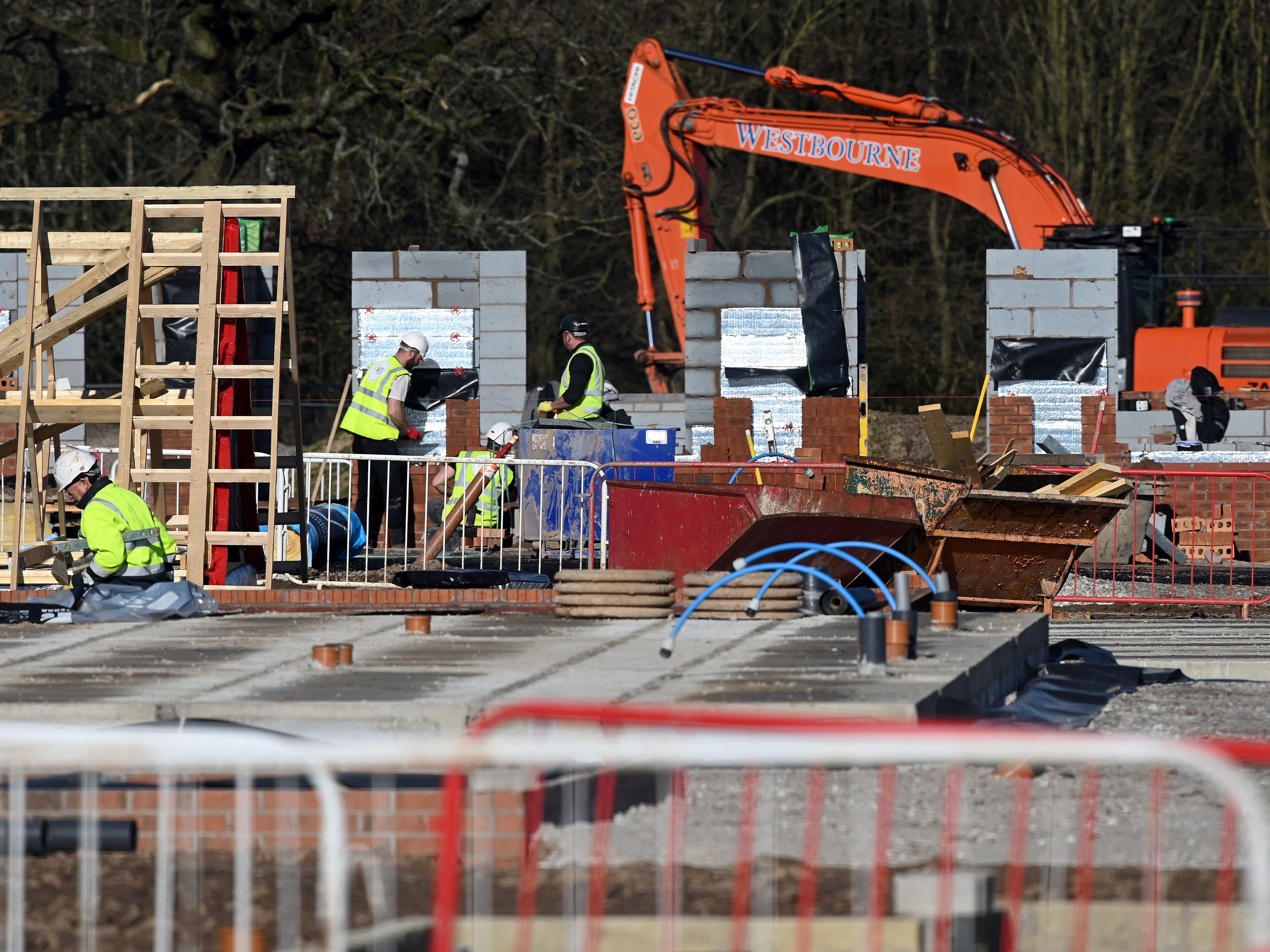 <p>Construction work at a building site for new homes in north west England in March</p>