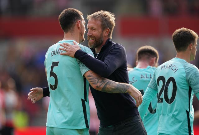 Graham Potter hugs Brighton defender Lewis Dunk after their 1-0 win at Brentford (Dominic Lipinski/PA)