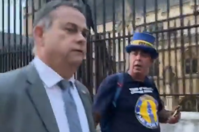 <p>Steve Bray confronts Foreign Office minster Nigel Adams outside parliament</p>