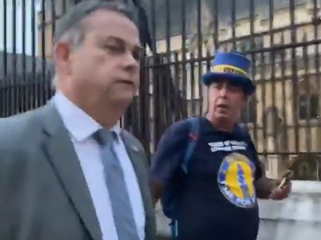 <p>Steve Bray confronts Foreign Office minster Nigel Adams outside parliament</p>
