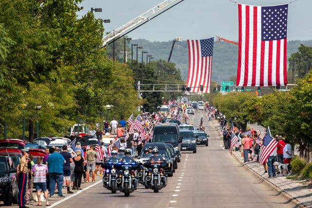 <p>People line Abbot Drive to pay their respects to Marine Cpl. Daegan Page as the procession carrying his body drives through Omaha, Neb. on Friday Sept. 10, 2021</p>