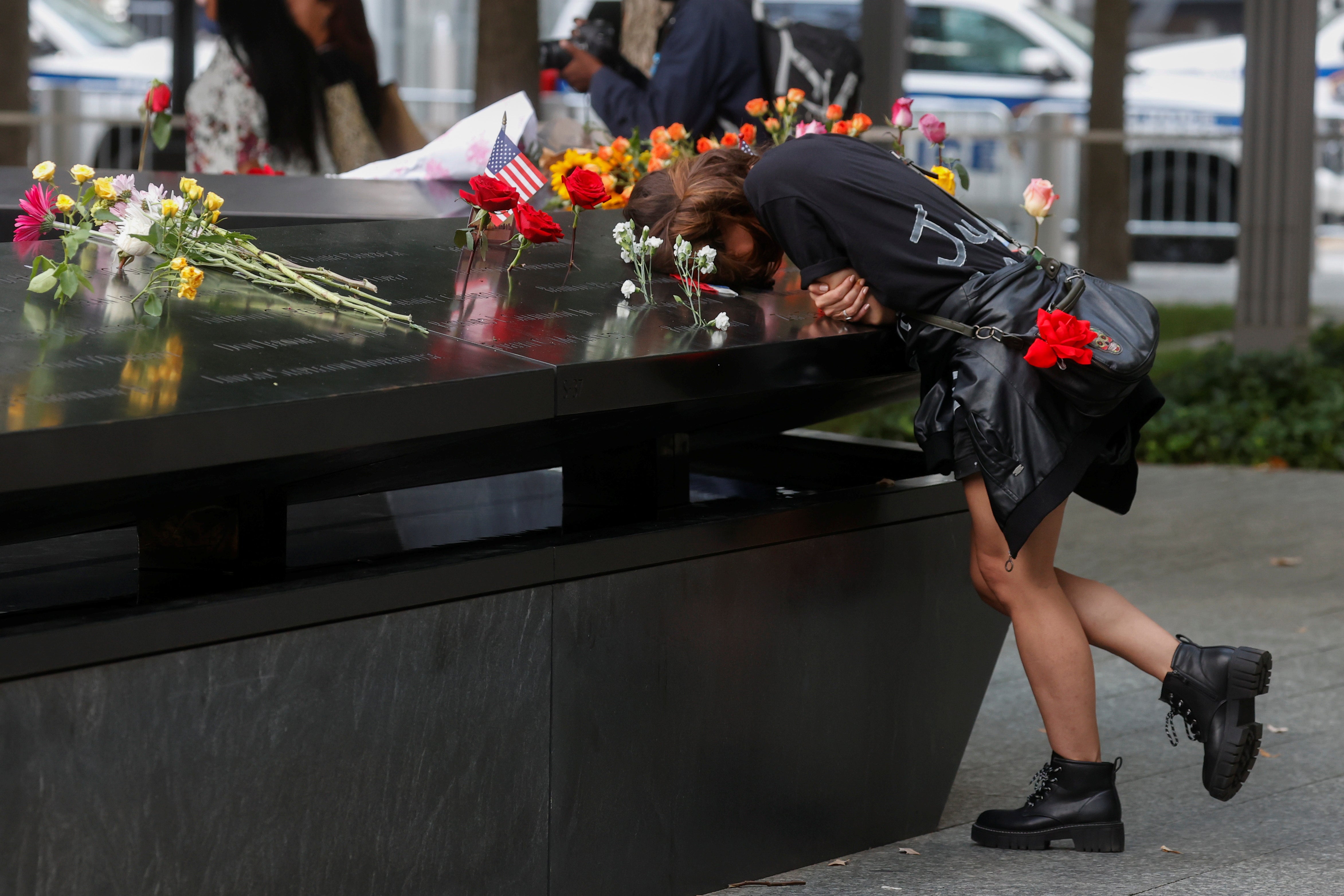 A person mourns at the 9/11 Memorial on the 20th anniversary of the September 11, 2001 attacks in New York City, New York, U.S., September 11, 2021. REUTERS/Brendan McDermid