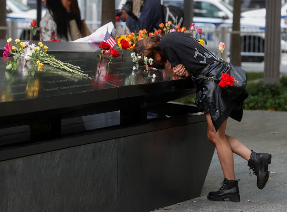 pA person mourns at the 9/11 Memorial on the 20th anniversary of the September 11, 2001 attacks in New York City, New York, U.S., September 11, 2021. REUTERS/Brendan McDermid/p