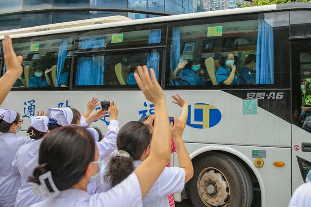 <p>Medical workers send off their colleagues leaving to help with an outbreak of Covid-19 in Putian from a provincial hospital in Fujian.  </p>