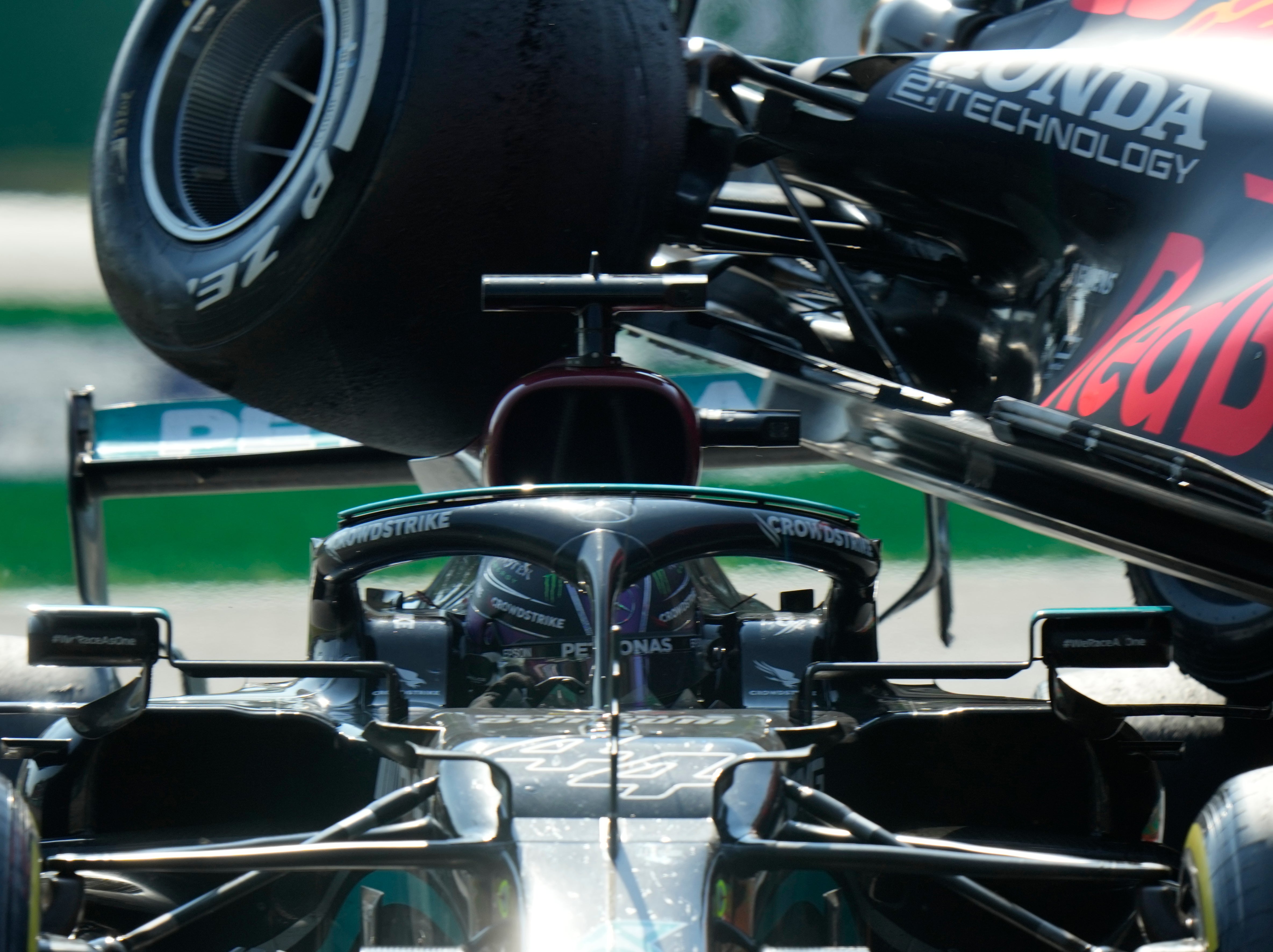 <p>Max Verstappen’s Red Bull goes over Lewis Hamilton’s Mercedes</p>