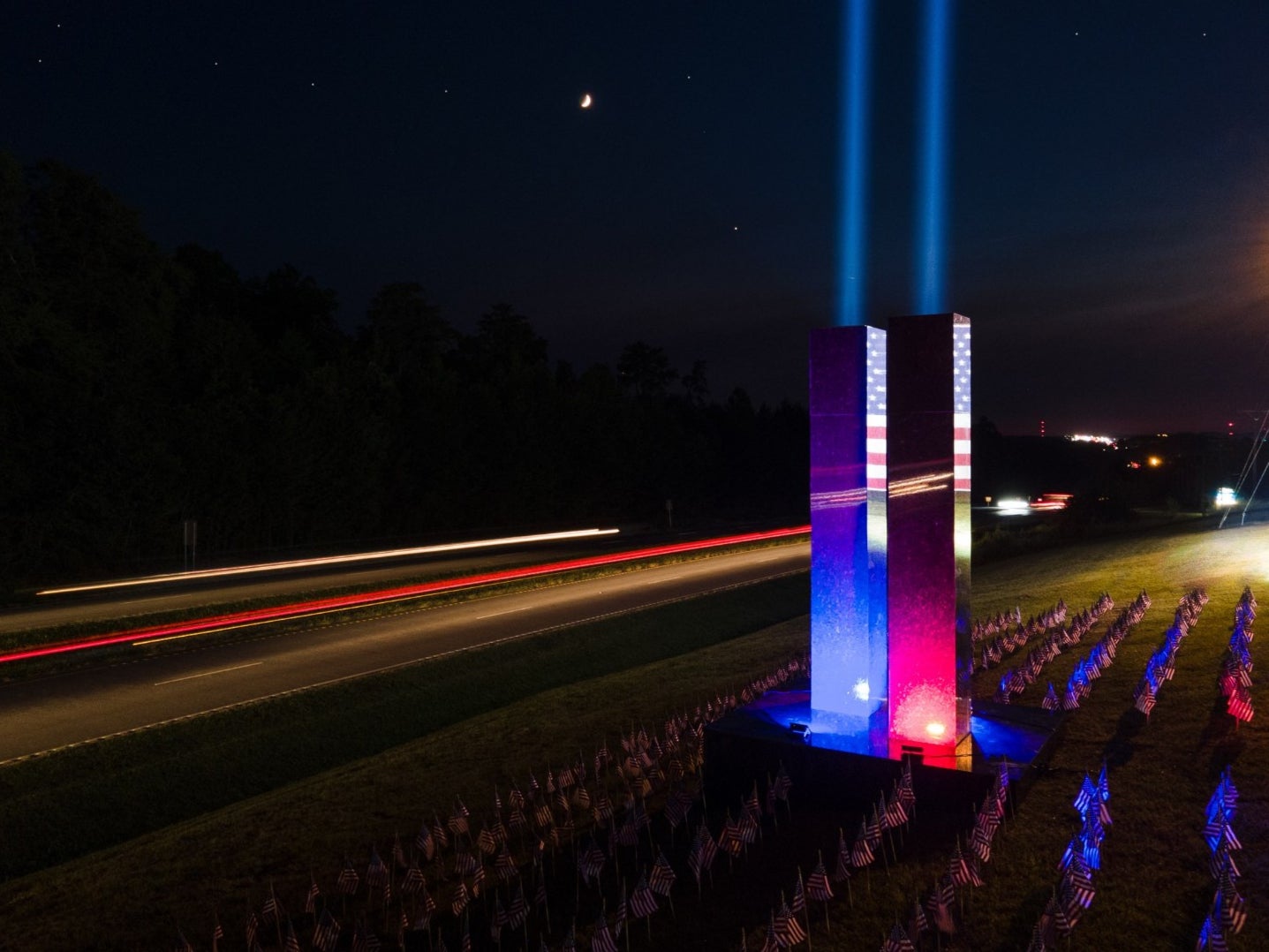 The 9/11 memorial at Upstate Granite Solutions in Greenville, South Carolina fully lit.