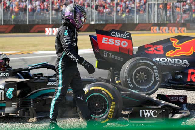 <p>Lewis Hamilton walks away from his Mercedes after colliding with Max Verstappen (Luca Bruno/AP)</p>