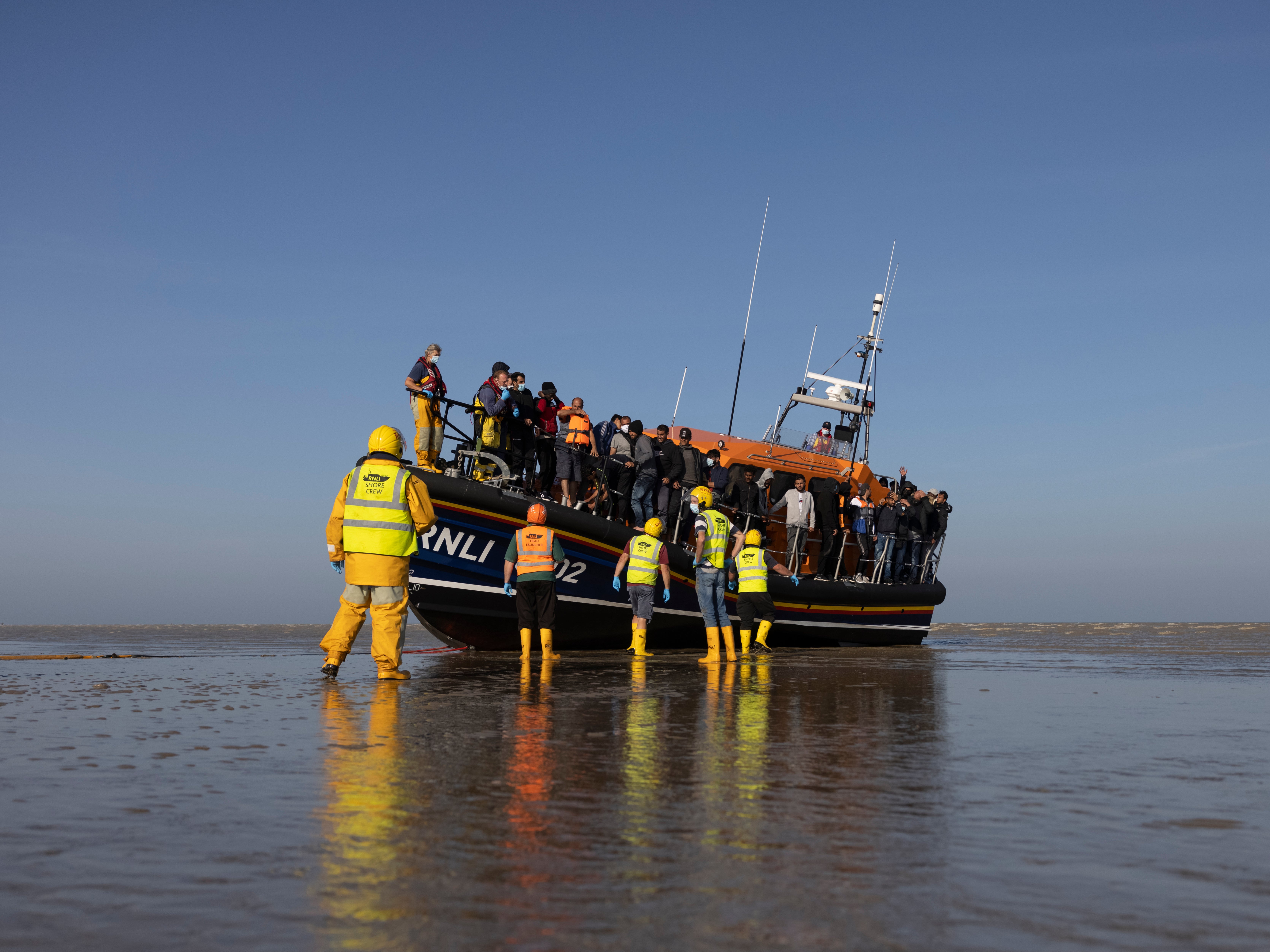 A group of asylum seekers arrive at Dungeness beach, Kent.