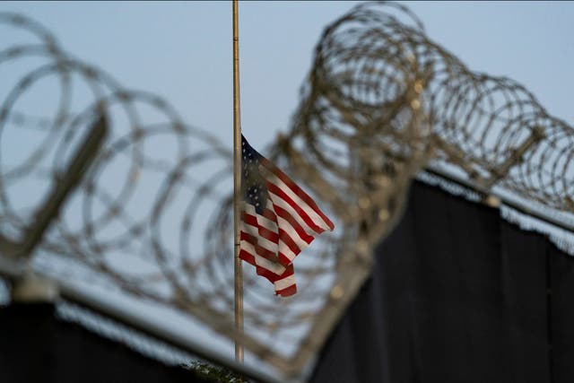 <p>A flag flying at half mast at Guantanamo Bay’s Camp Justice mast for the victims of a terror attack in Kabul</p>
