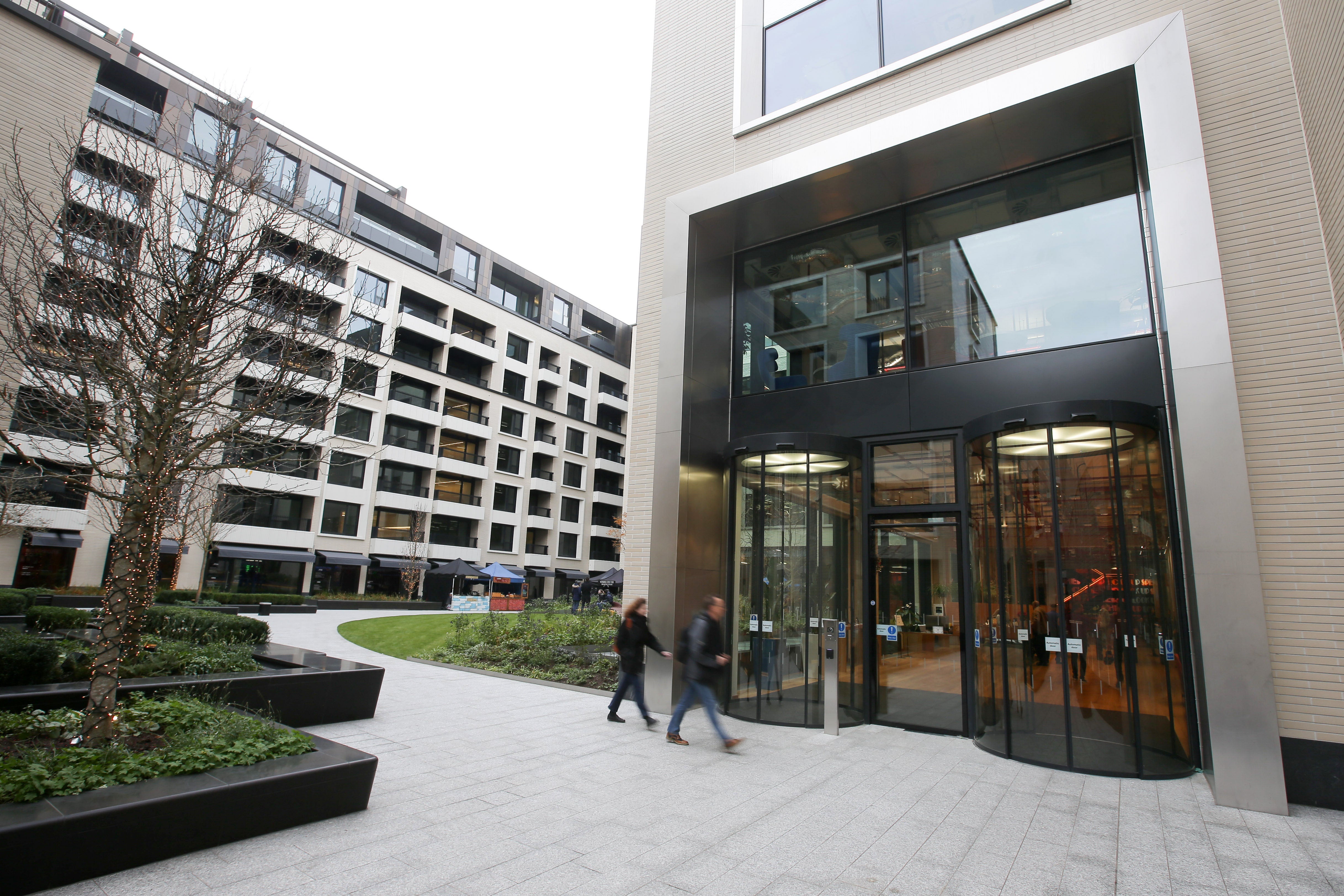 Employees at the entrance of Facebook's new headquarters in London, designed by Canadian-born American architect Frank Gehry