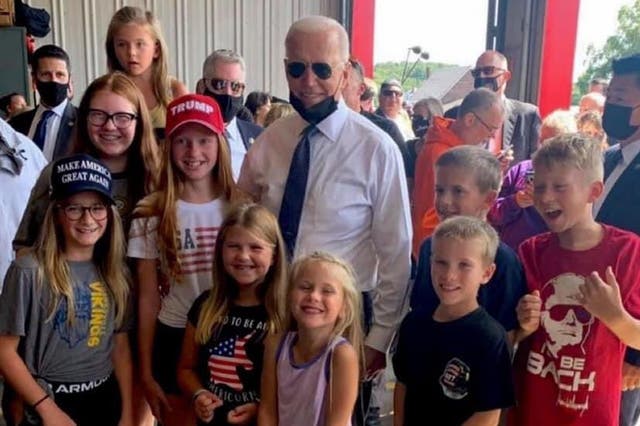 <p>President Joe Biden posed for a photo with children wearing pro-Trump clothing</p>