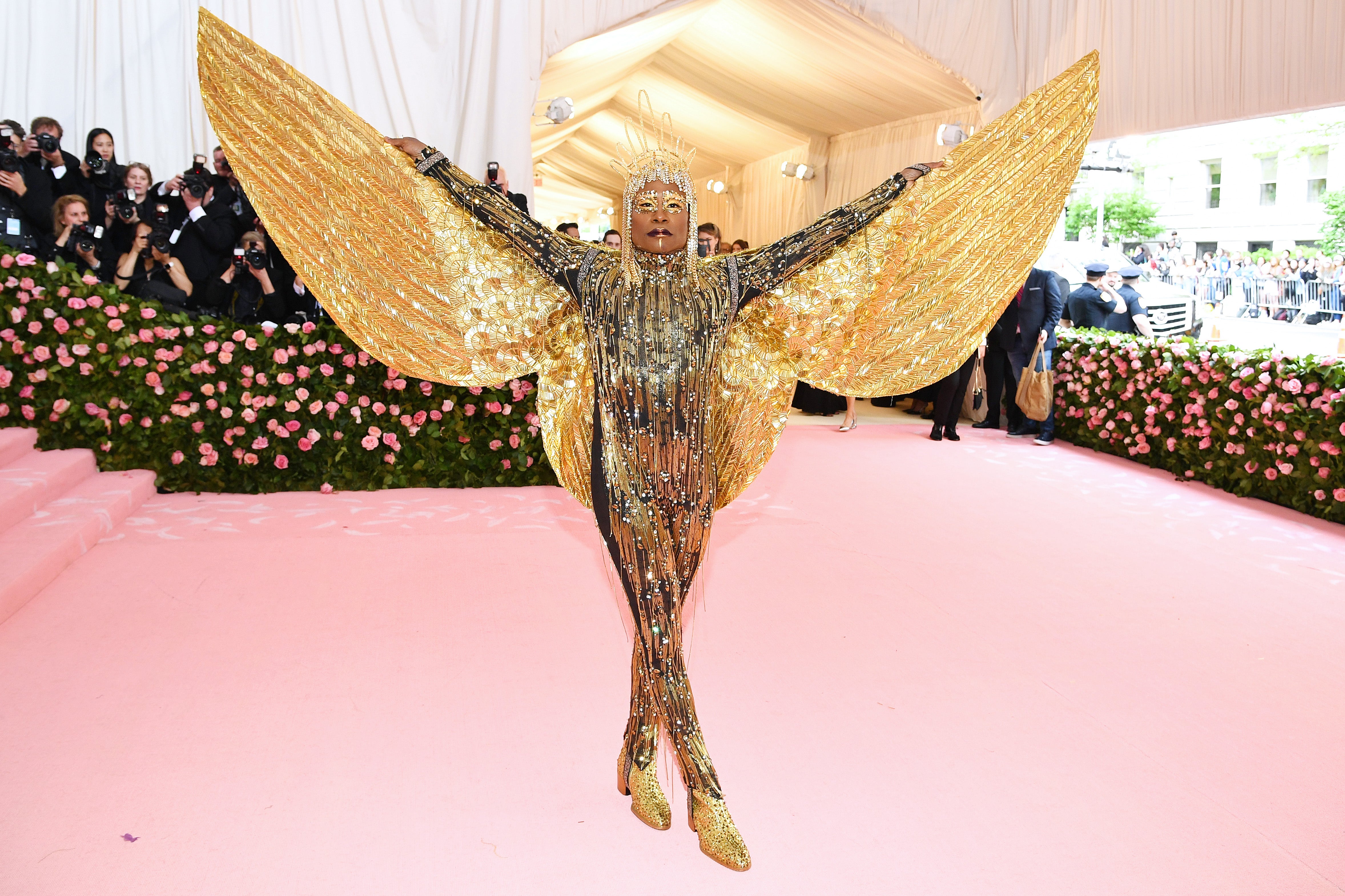 Porter with golden wings on the Met Gala red carpet in 2019