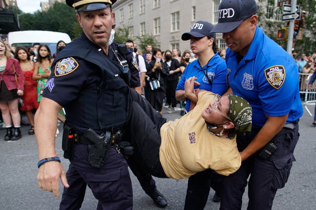 <p>Protestor seen being carried away after demonstration in front of Met Gala</p>