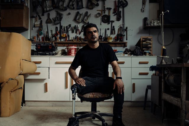 <p>Mohammed Zidane, 40, sitting in his carpentry and upholstery workshop in Jebaliya Camp, Gaza, lost his leg during the fierce fighting of Gaza’s first war, which started in 2008</p>