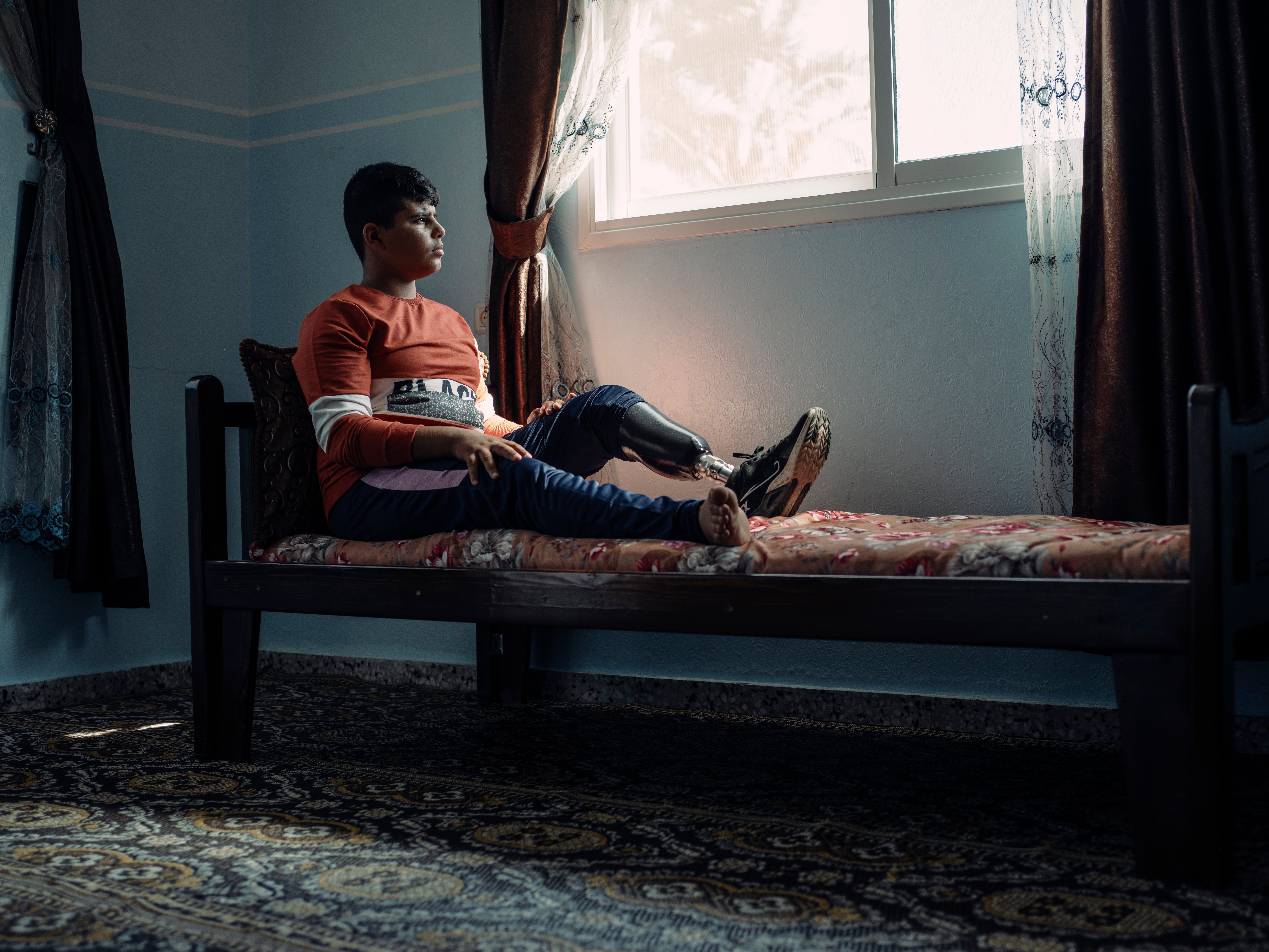 Mohammed, who lives in the Bedouin area of Mousadar in Gaza, was watching television on 12 November 2019 when a tank shell was fired directly at his home. He lost his left leg in the blast