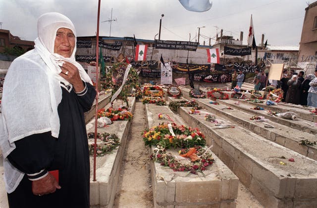 <p>A Lebanese woman by the graves of the 105 civilians killed when Israeli artillery shelled the UN compound in Qana during Israel's ‘Grapes of Wrath’ offensive</p>