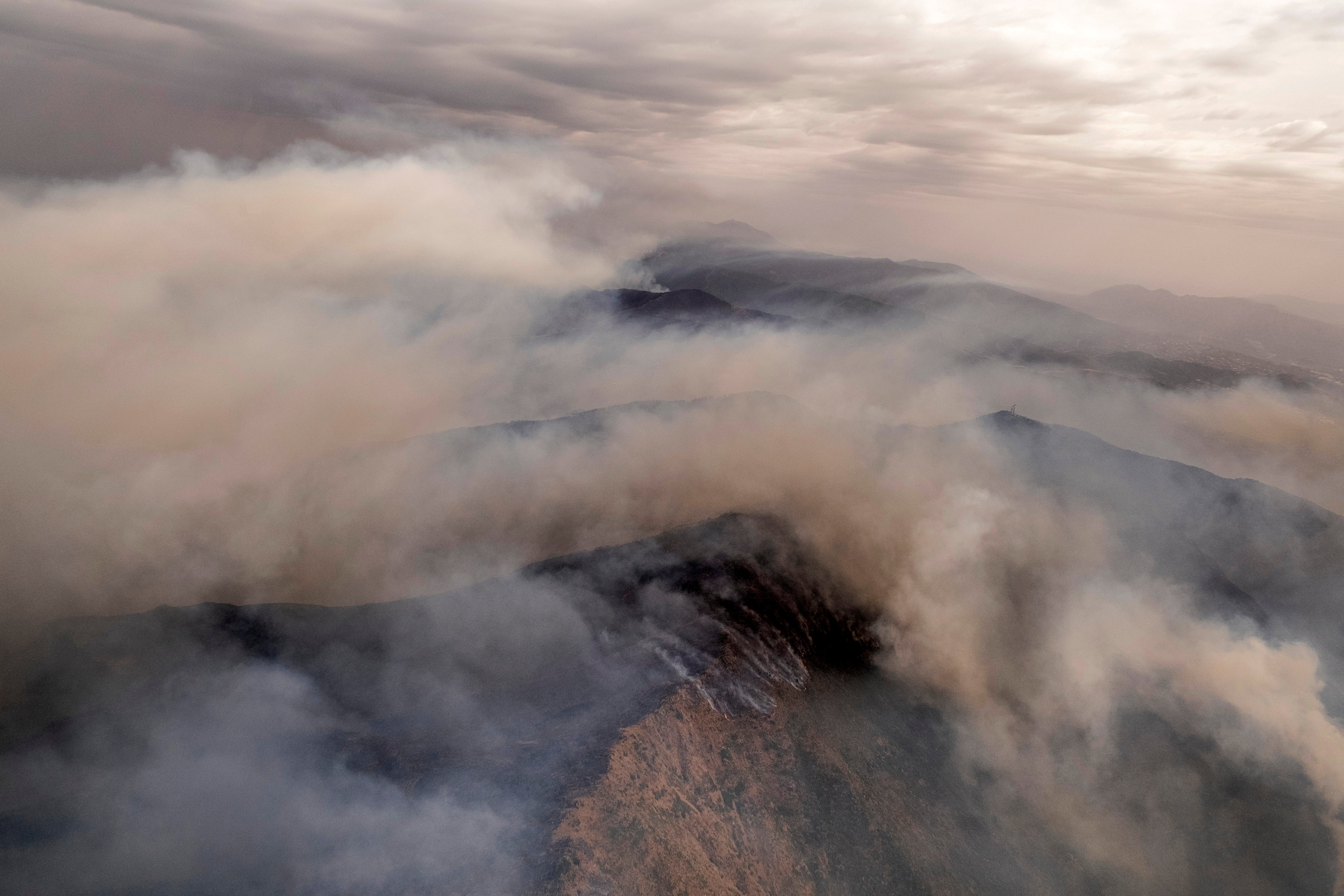 Smoke filled mountains near the town of Jubrique, in Malaga province