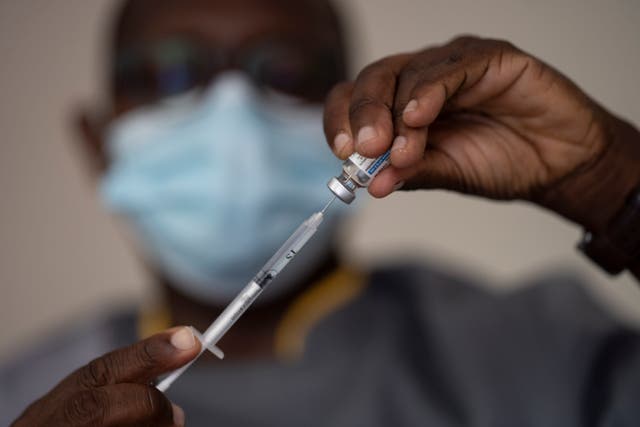 <p>A health worker administers a dose of the Johnson & Johnson Covid-19 vaccine</p>