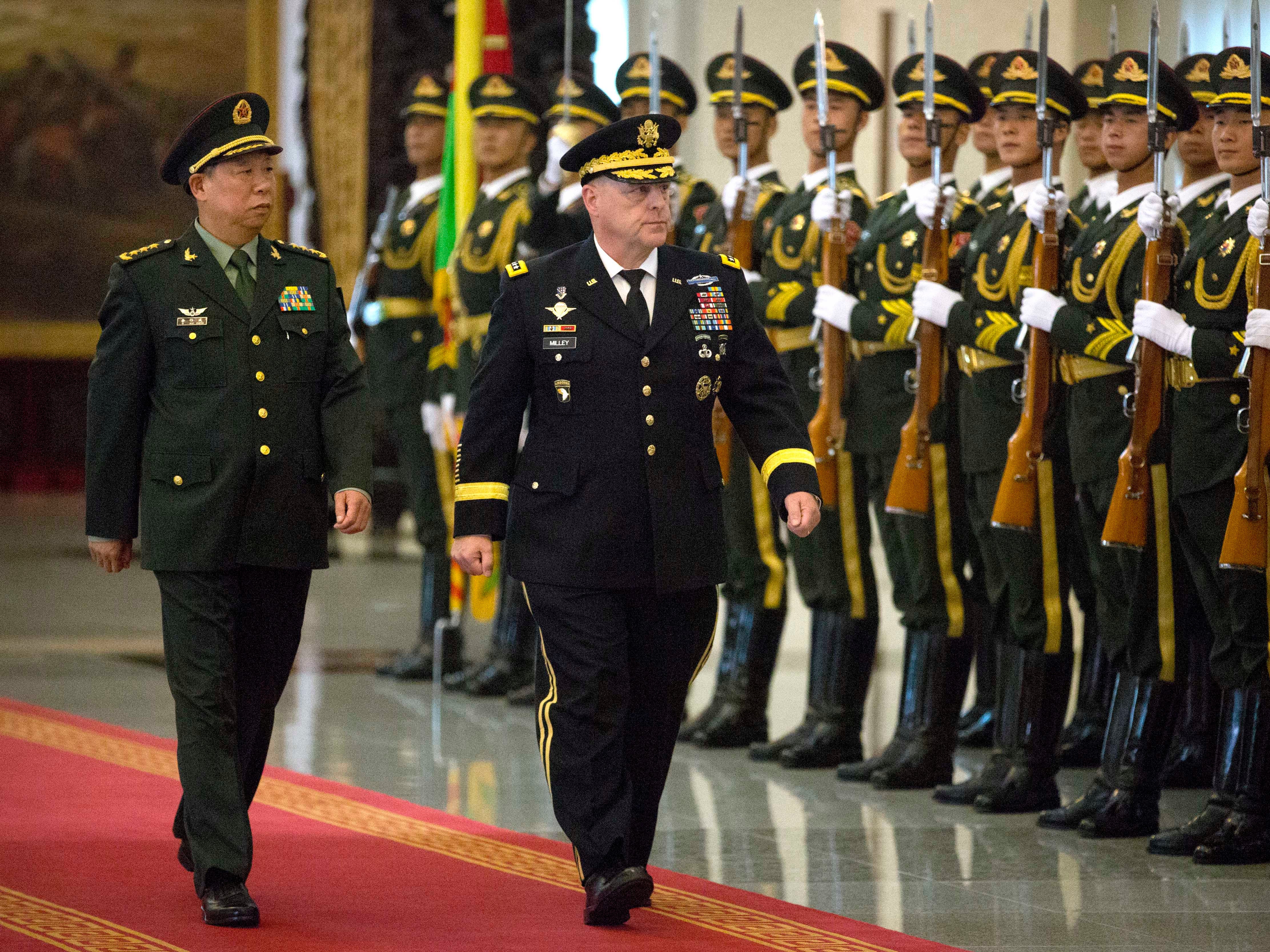 China’s People’s Liberation Army General Li Zuocheng and then-US Army Chief of Staff General Mark Milley review an honour guard during a welcome ceremony at the Bayi Building in Beijing on August 16, 2016