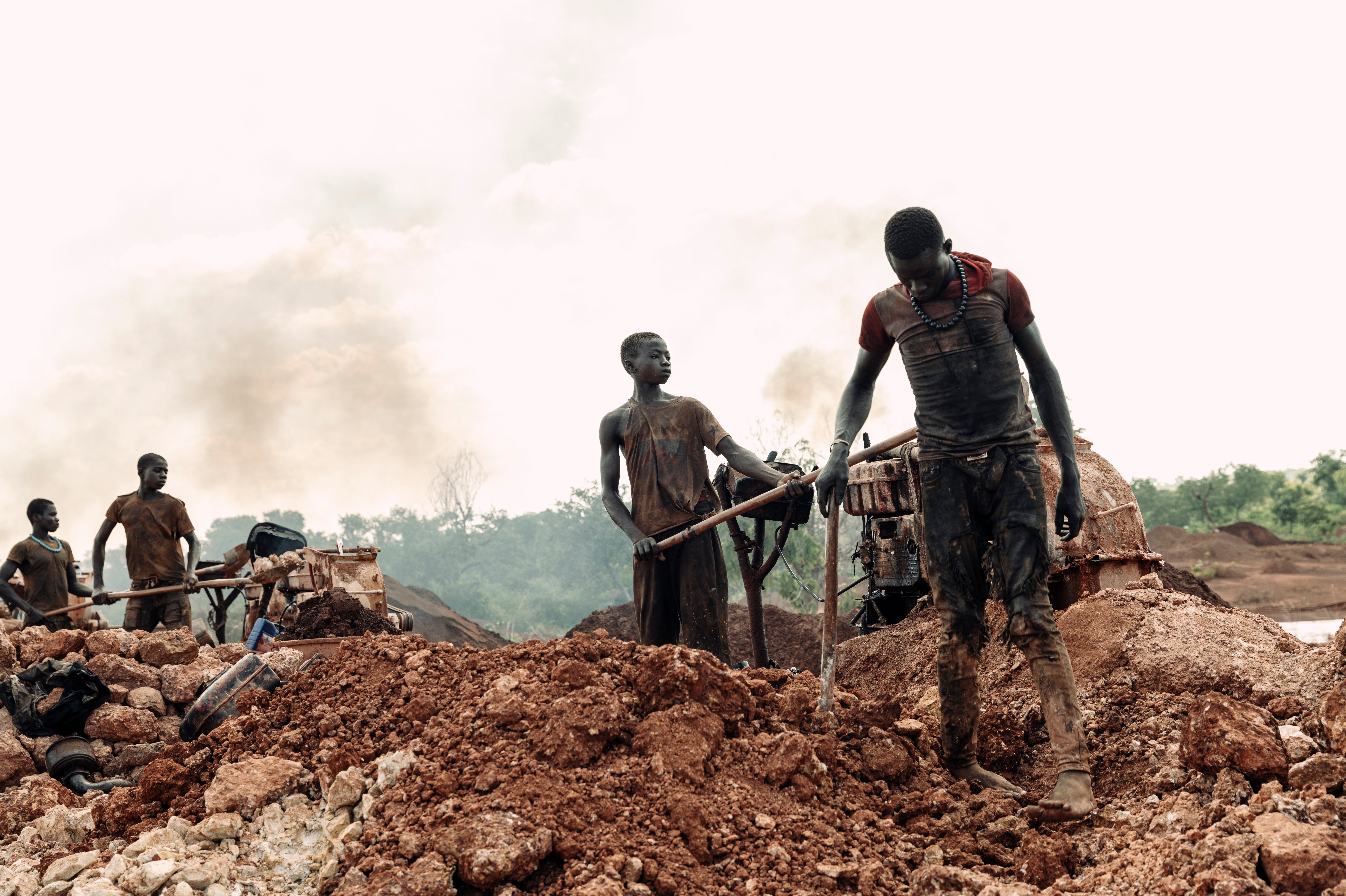 The boys from Burkina Faso lined up, shovelling gold bearing rock into crushers with robotic fashion, toiling under the midday sun, obscured behind plumes of noxious diesel soot