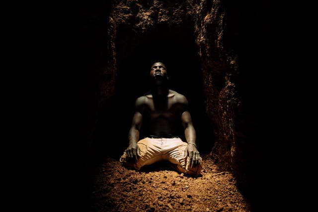 <p>A miner kneeling at the bottom of a deep shaft catches his glimpse of daylight before retreating along a tunnel which extends as far as 200 metres</p>