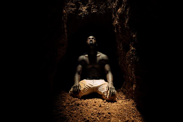 <p>A miner kneeling at the bottom of a deep shaft catches his glimpse of daylight before retreating along a tunnel which extends as far as 200 metres</p>