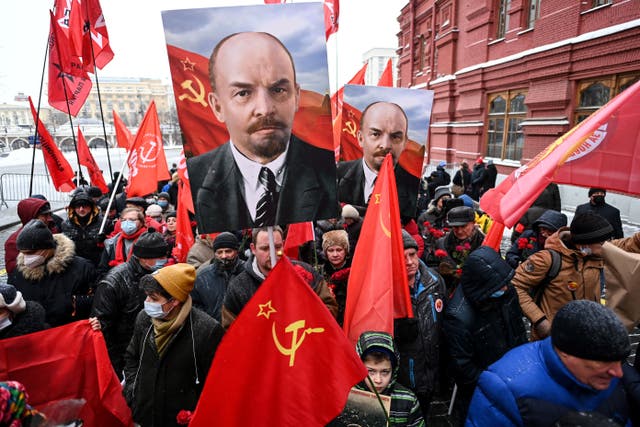 <p>Russian Communist Party supporters walk towards the mausoleum of Lenin in January</p>