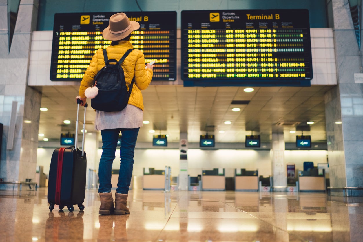 A woman checks the flight schedule at Barcelona airport