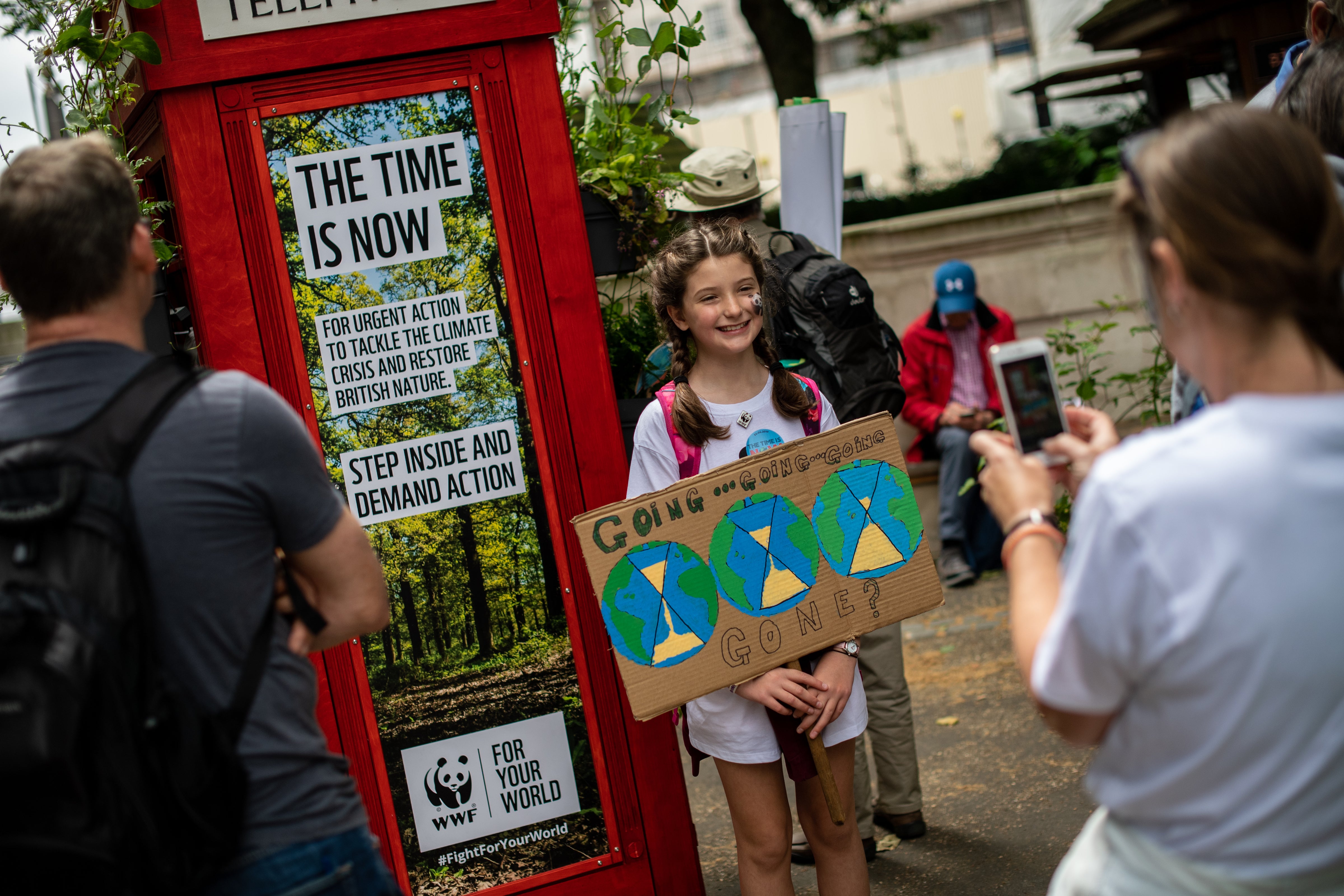 A child has her photo taken at a telephone box in Victoria Gardens, London, inviting the public to leave messages demanding urgent action from their MP’s to tackle the climate and nature crisis. Before the pandemic, WWF joined over 130 organisations and 15,000 people as part of the biggest mass lobby for climate and nature even seen in the UK