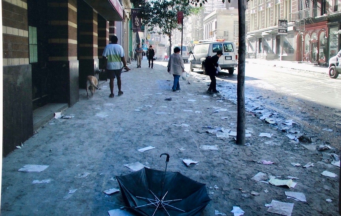 Mr Hill pictured walking his dog outside his apartment the day after 9/11