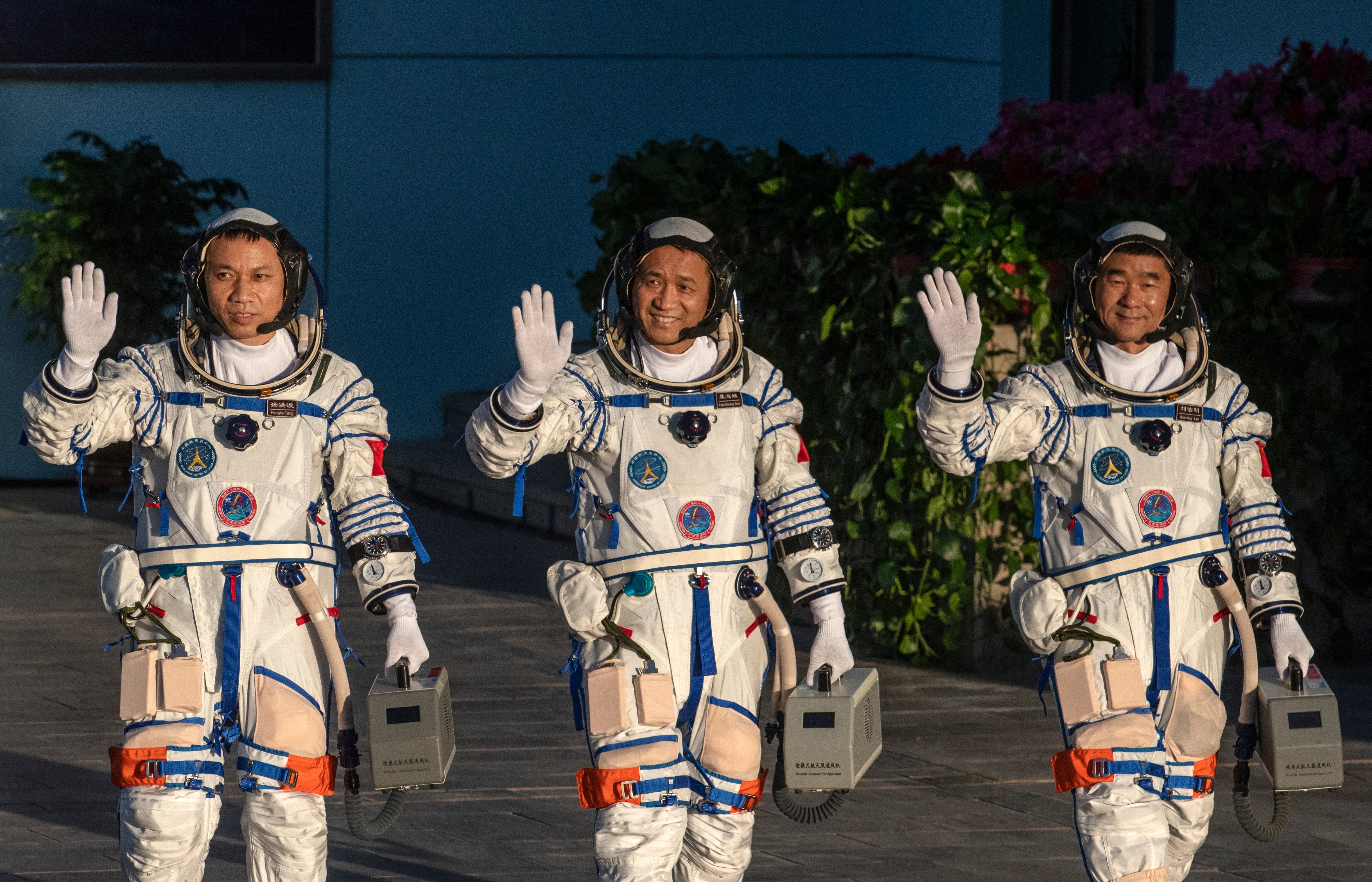 <p>File. Chinese astronauts from China’s Manned Space Agency - left to right, Tang Hongbo, Nie Haisheng, and Liu Boming - wave at a departure ceremony before launch of Senzhou-12</p>