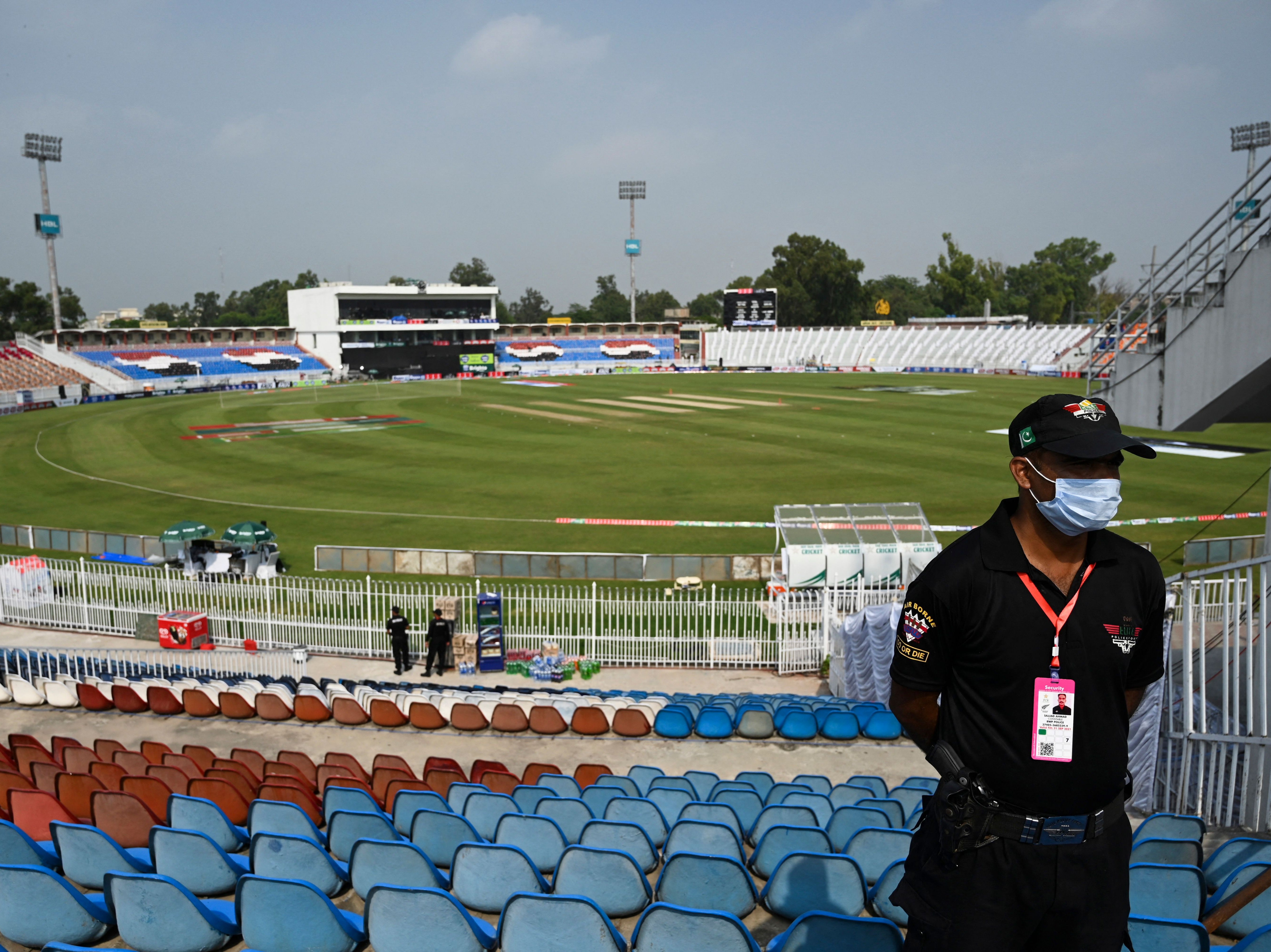A policeman stands guard on the empty stands of the Rawalpindi Cricket Stadium in Rawalpindi