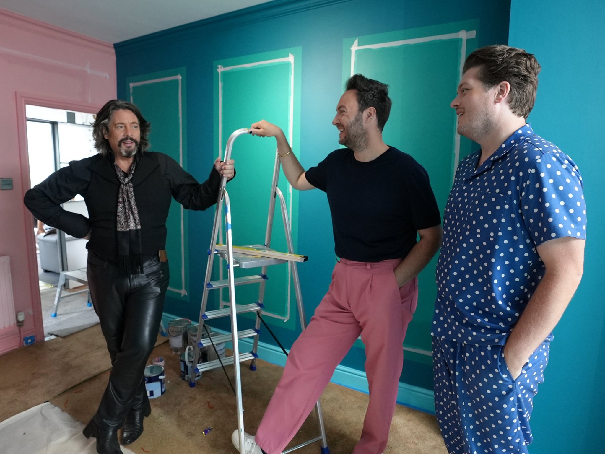 Part dandy highwayman, part sex dungeon captive: Laurence Llewelyn-Bowen amuses Jordan Cluroe and Russell Whitehead in the rebooted ‘Changing Rooms'