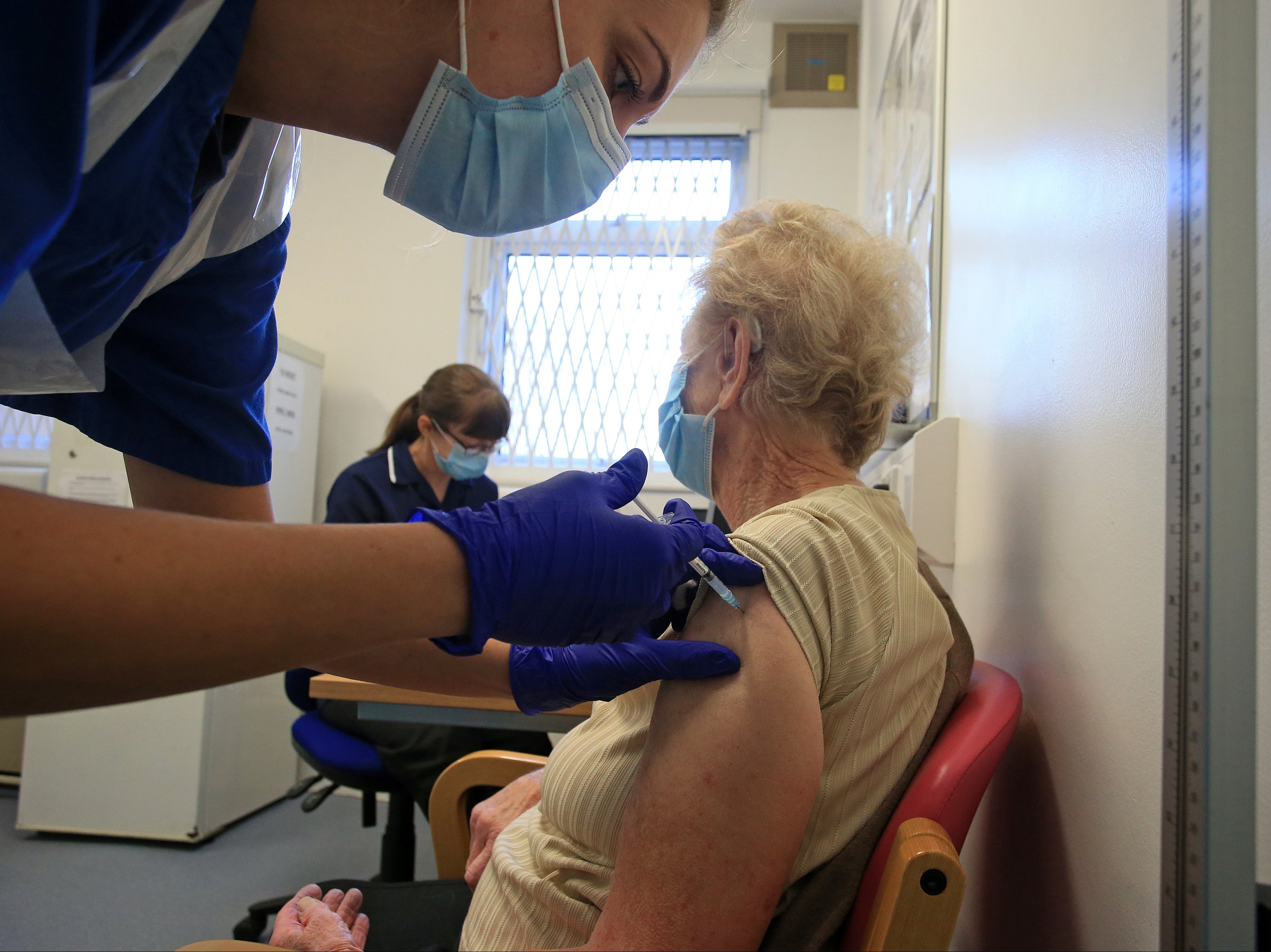 A nurse at a GP practice in Haxby vaccinates an elderly patient