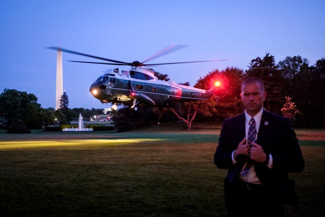 <p>A Secret Service agent keeps watch as President Donald Trump arrives aboard Marine One on the South Lawn of the White House on May 23, 2018 in Washington, DC. </p>