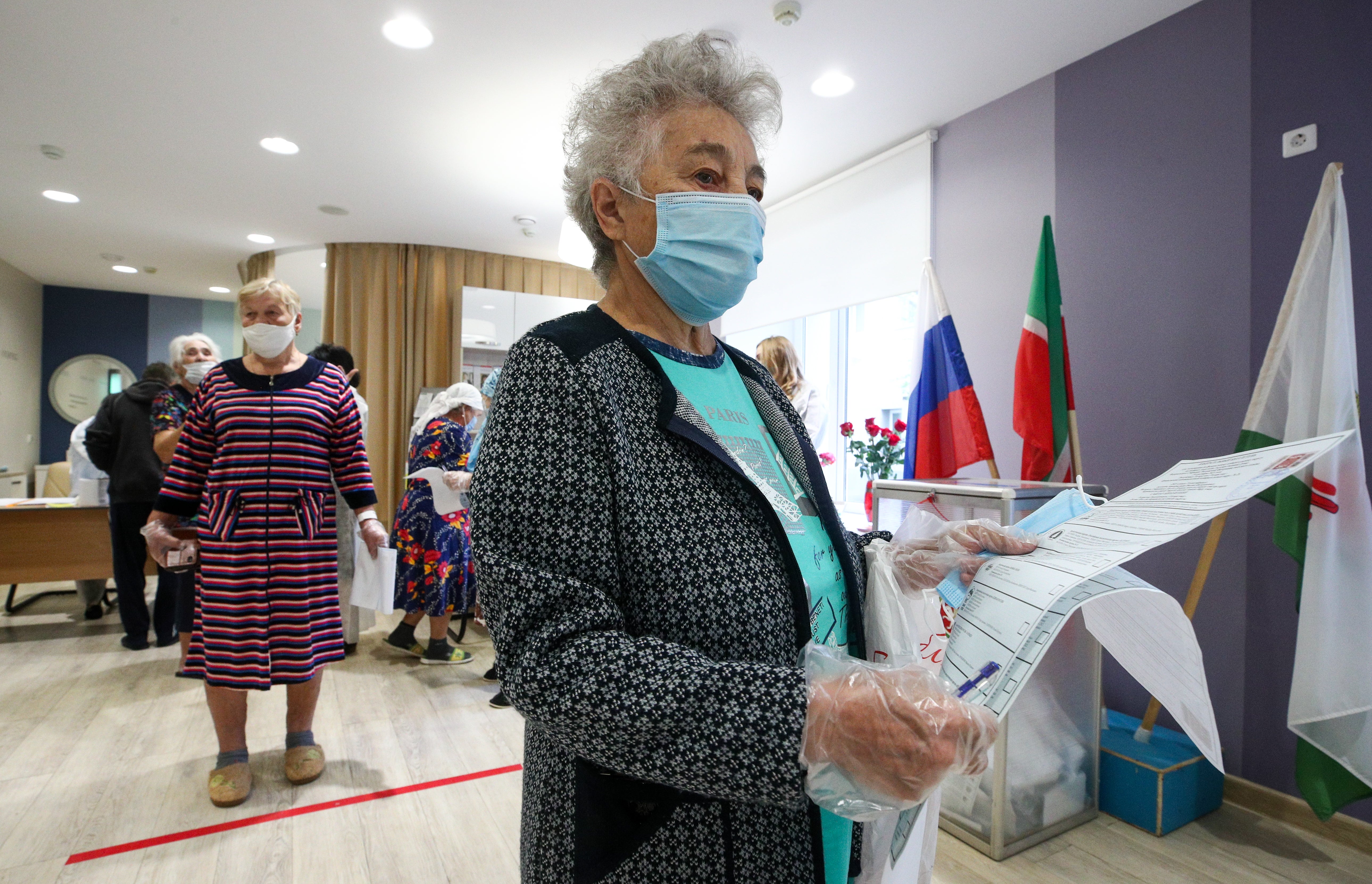 <p>A voter holds ballots during the Russian parliamentary election at polling station 342 at the Republican Clinical Hospital in Kazan on Sunday </p>