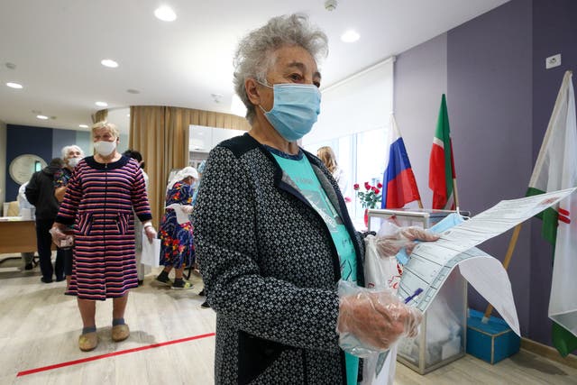 <p>A voter holds ballots during the Russian parliamentary election at polling station 342 at the Republican Clinical Hospital in Kazan on Sunday </p>