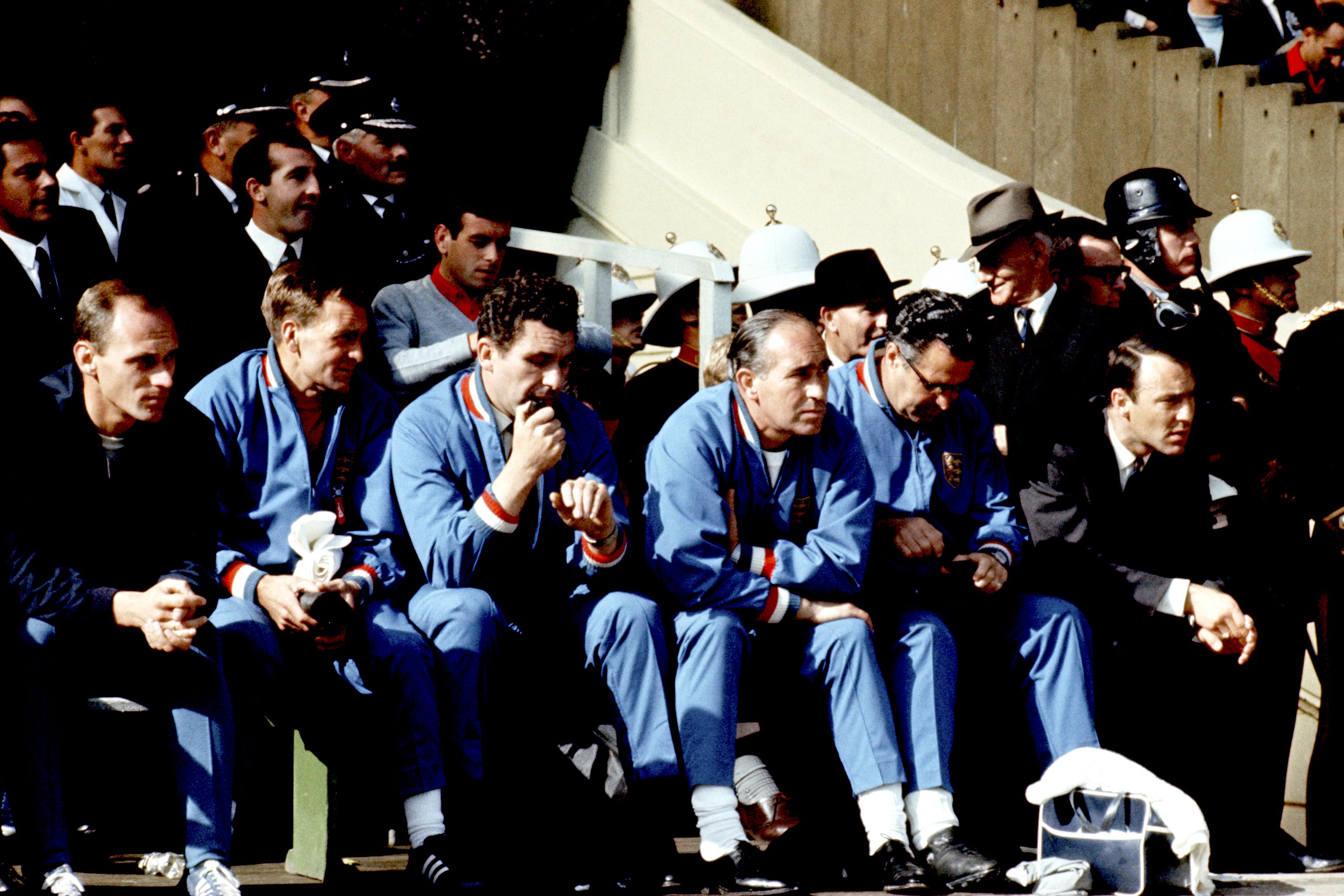 Jimmy Greaves, dressed in his suit (sat far right), watched the 1966 World Cup final from the touchline (PA)