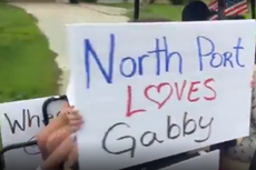 Laundrie family beset by protesters with signs and megaphone outside their Florida home
