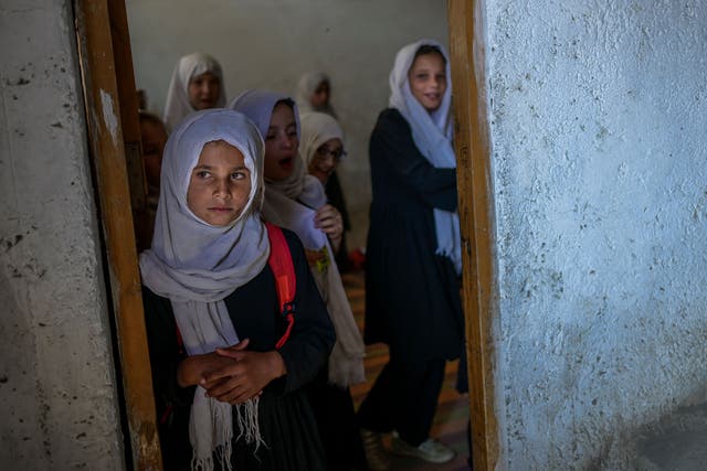 <p>Schoolgirls gather at their class after arriving at a gender-segregated school in Kabul on 15 September 2021</p>