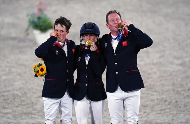 Tom McEwen (left) celebrates Olympic gold with Laura Collett and Oliver Townend (Adam Davy/PA)