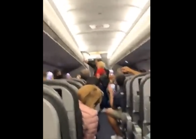 <p>Shaky footage shows fellow passengers breaking out in song</p>