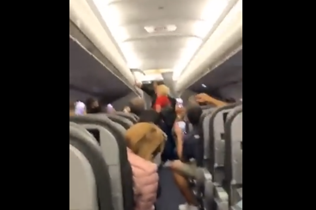 <p>Shaky footage shows fellow passengers breaking out in song</p>