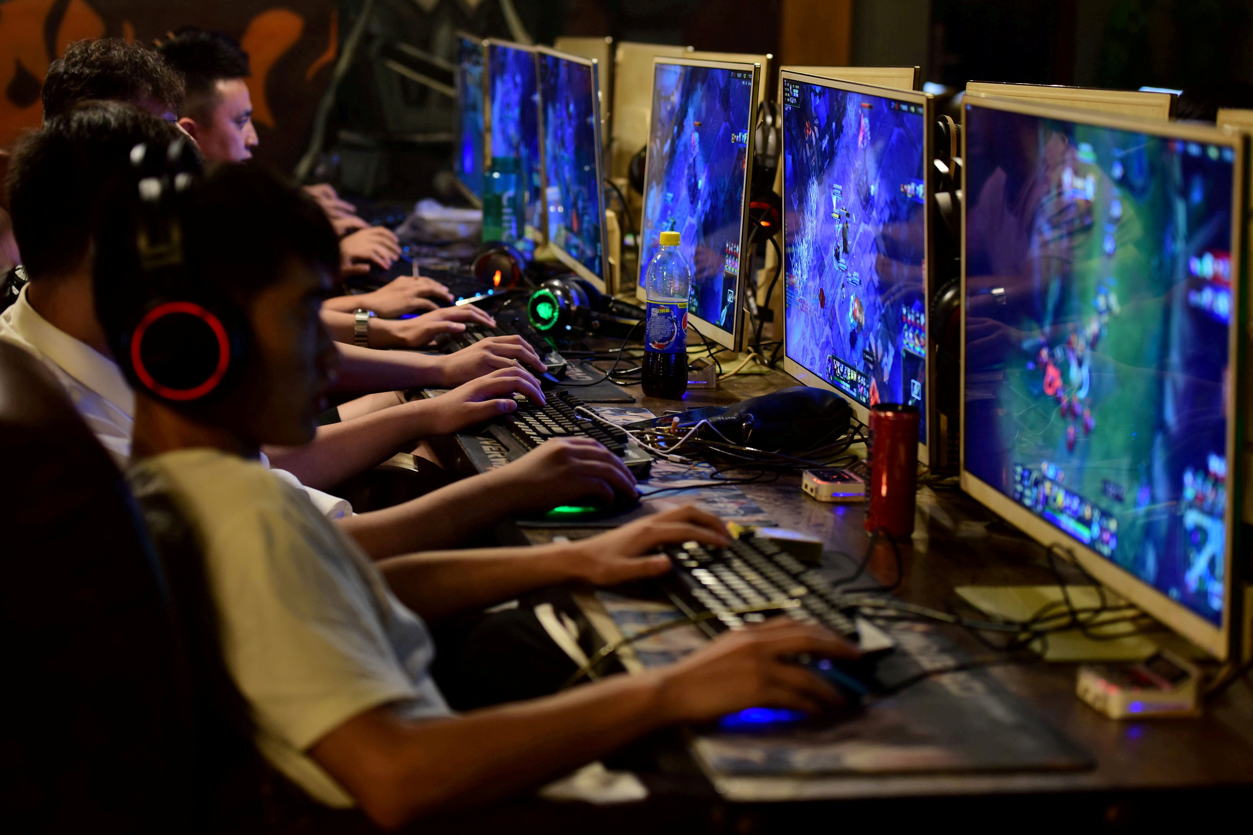 People play online games at an internet cafe in Fuyang, Anhui province